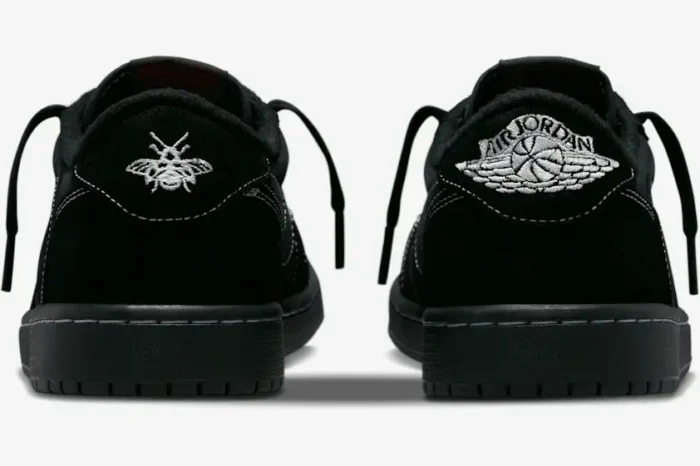 Rear view of black Air Jordan 1 Low OG x Travis Scott Black Phantom sneakers with white embroidered logos. - SKU DM7866-001