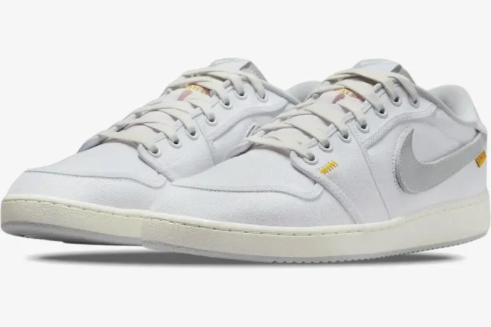 Air Jordan 1 Low x Union LA sneakers in white and neutral grey, shown from a three-quarter front angle. - SKU DO8912-101