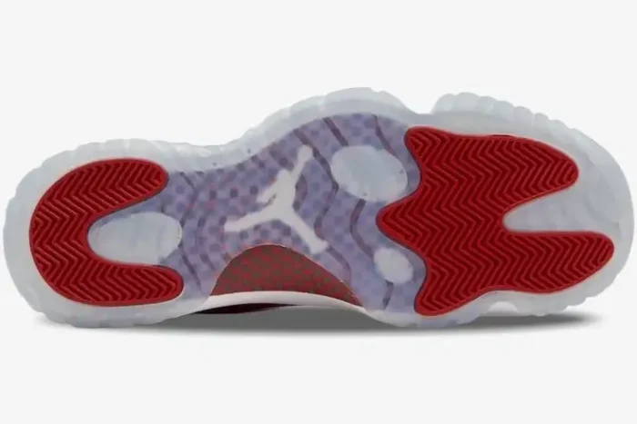 Bottom view of Air Jordan 11 Retro Cherry featuring a translucent outsole and red traction pods. - SKU CT8012-116