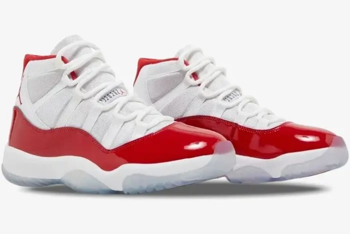 A pair of Air Jordan 11 Retro Cherry sneakers in white and varsity red, shown from a side-angled view. - SKU CT8012-116