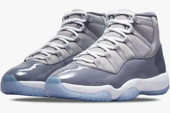 Air Jordan 11 Retro Cool Grey sneakers in a three-quarter front view with white laces and icy blue outsoles. - SKU CT8012-005