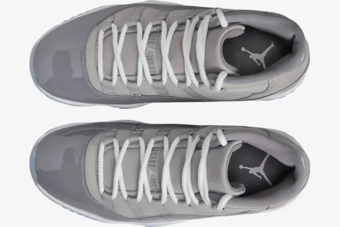 Top-down view of Air Jordan 11 Retro Cool Grey sneakers featuring white laces and grey patent leather mudguards. - SKU CT8012-005