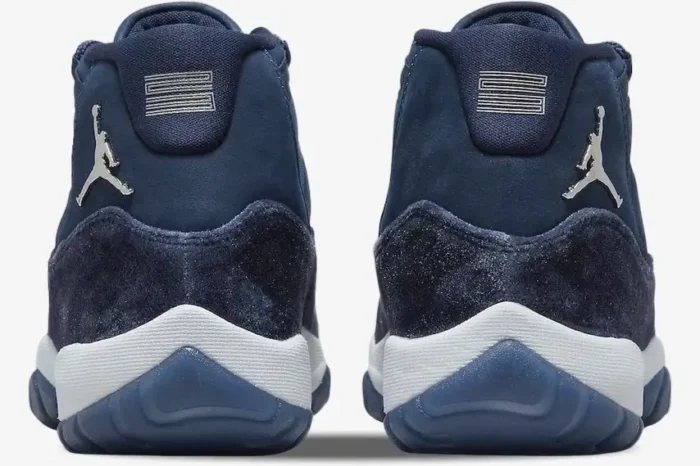 Rear view of Women's Air Jordan 11 Retro Midnight Navy Velvet sneakers with silver Jumpman logos. - SKU AR0715-441