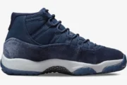 Side profile of the Women's Air Jordan 11 Retro 'Midnight Navy' sneaker with a navy velvet upper and white midsole. - SKU AR0715-441