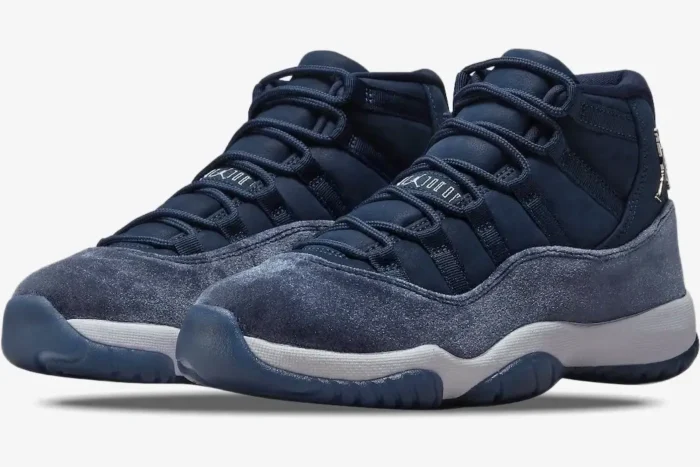 Three-quarter view of women's Air Jordan 11 Retro 'Midnight Navy' sneakers with velvet and suede details. - SKU AR0715-441