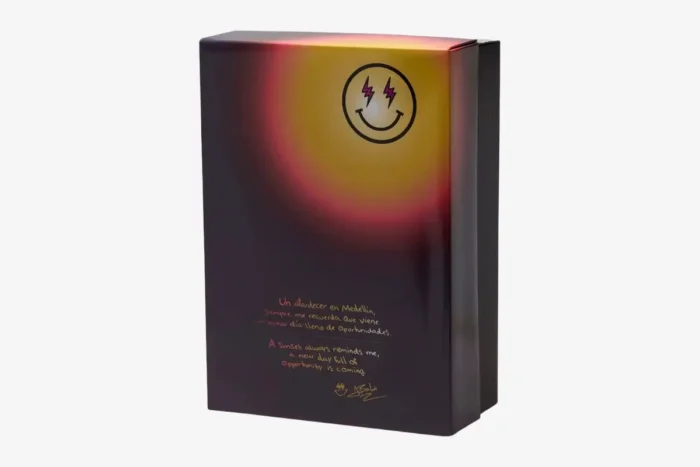 Back view of the Air Jordan 3 x J Balvin Medellín Sunset shoebox featuring a gradient design and smiley logo. - SKU FN0344-901