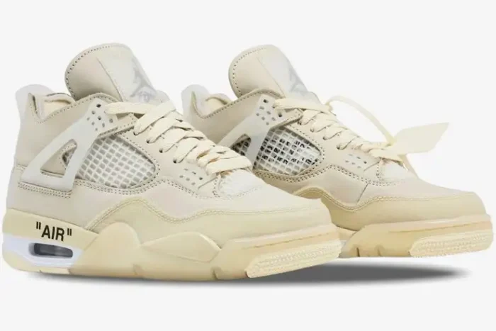 Three-quarter view of women's Air Jordan 4 Retro x Off-White Sail sneakers in a monochromatic cream colorway. - SKU CV9388-100