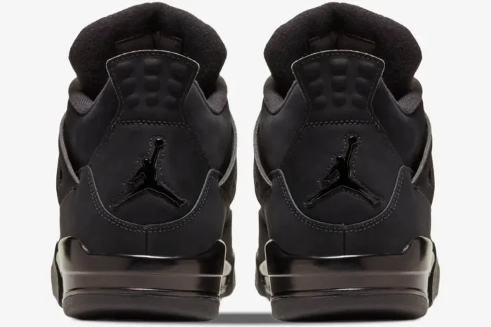 Rear view of Air Jordan 4 Retro Black Cat sneakers in all black with glossy Jumpman logos on the heels. - SKU CU1110-010