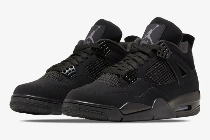 A pair of all-black Air Jordan 4 Retro Black Cat sneakers shown from a three-quarter side angle. - SKU CU1110-010