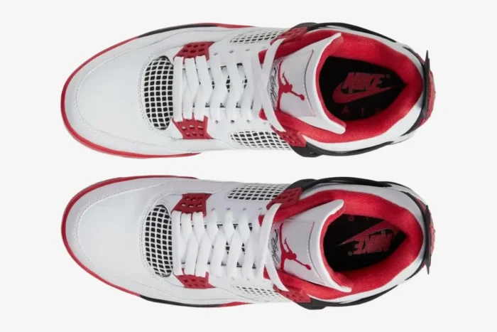 Top-down view of Air Jordan 4 Retro Fire Red sneakers in white, red, and black with white laces. - SKU DC7770-160