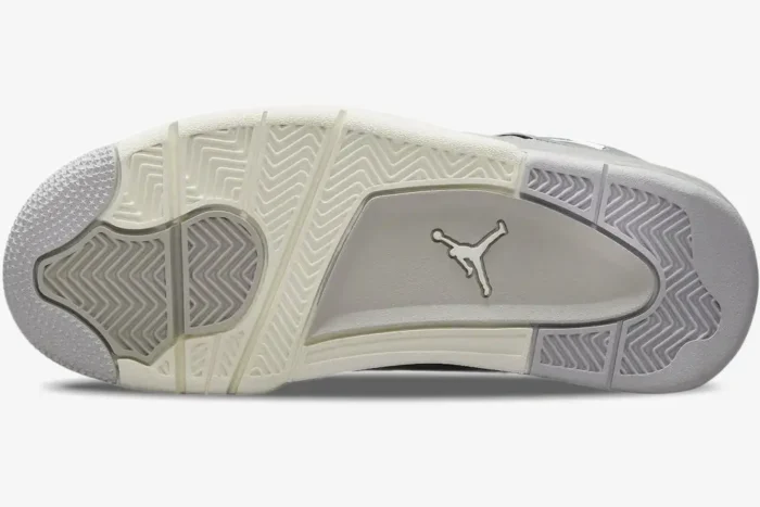 Bottom view of the Air Jordan 4 Retro Frozen Moments outsole in sail and grey with Jumpman logo. - SKU AQ9129-001
