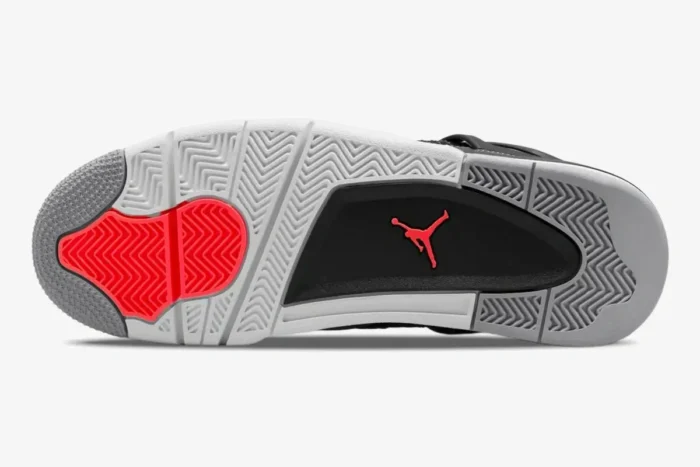 Bottom view of Air Jordan 4 Retro Infrared outsole featuring grey, white, and red herringbone traction patterns. - SKU DH6927-061
