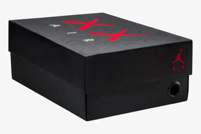 Black Air Jordan 4 Retro x Kaws shoebox with red branding, three-quarter perspective view. - SKU 930155-003
