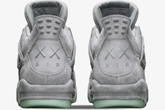 Rear view of Air Jordan 4 Retro x Kaws sneakers in cool grey suede with XX heel branding. - SKU 930155-003