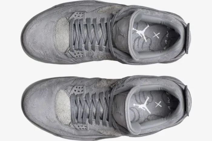 Top-down view of grey suede Air Jordan 4 Retro x Kaws sneakers featuring signature embroidery and branded insoles. - SKU 930155-003