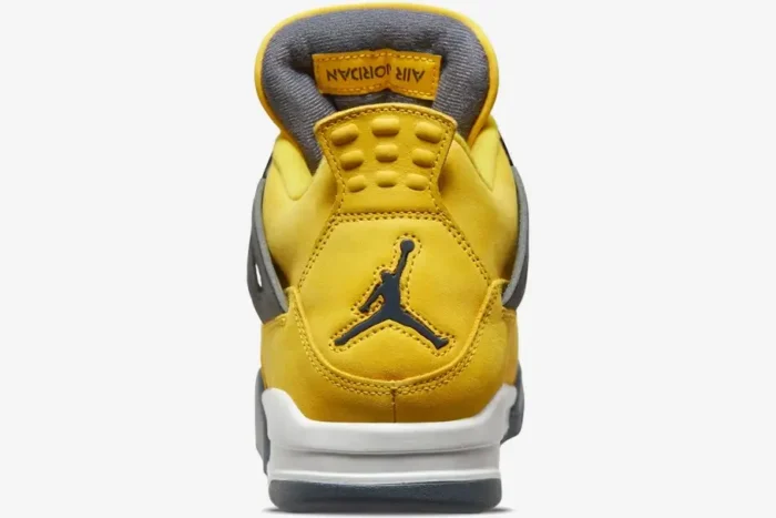 Heel view of the Air Jordan 4 Retro Lightning sneaker in yellow suede with a dark grey Jumpman logo. - SKU CT8527-700