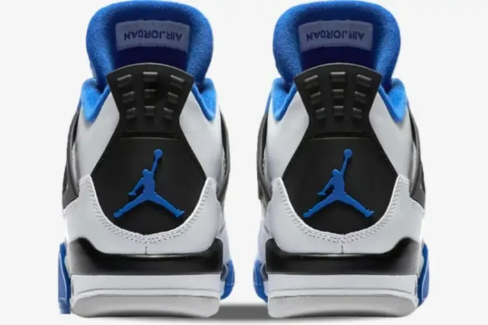 Rear view of Air Jordan 4 Retro Motorsports sneakers in white, black, and blue with Jumpman heel logo. - SKU 308497-117
