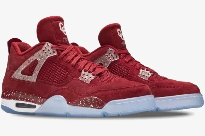 Side view of red suede Air Jordan 4 Retro Oklahoma Sooners PE sneakers with speckled details and icy blue soles.