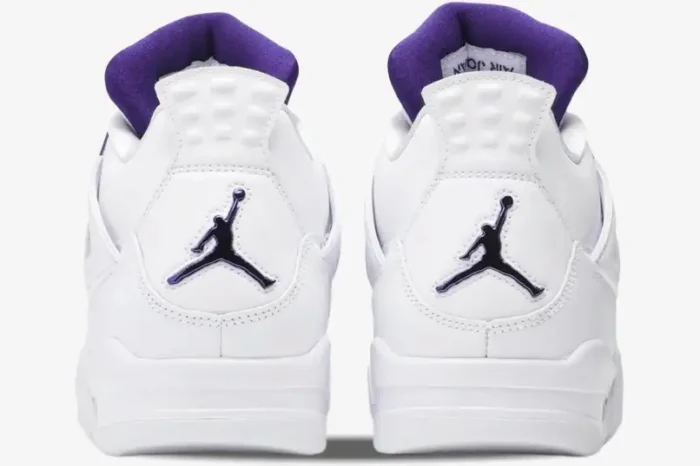 Rear view of white Air Jordan 4 Retro Purple Metallic sneakers showing the purple Jumpman logo on the heels. - SKU CT8527-115