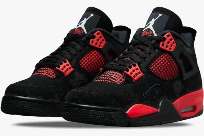 Air Jordan 4 Retro Red Thunder sneakers in black and red, shown from a three-quarter front angle. - SKU CT8527-016