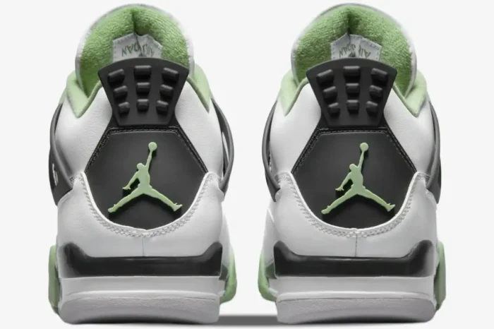 Rear view of Air Jordan 4 Retro Seafoam Oil Green sneakers with light green Jumpman logo on black heel tabs. - SKU AQ9129-103