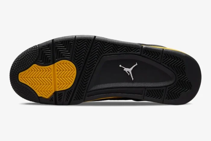 Bottom outsole view of Air Jordan 4 Retro Thunder in black and tour yellow. - SKU DH6927-017