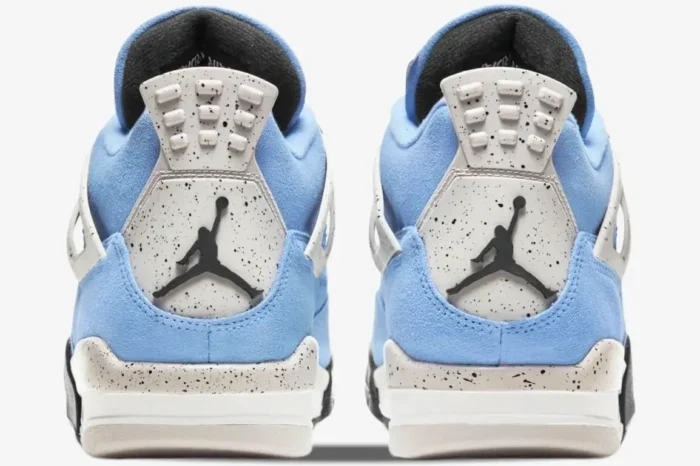 Rear view of Air Jordan 4 Retro University Blue sneakers with blue suede and speckled grey heel tabs. - SKU CT8527-400