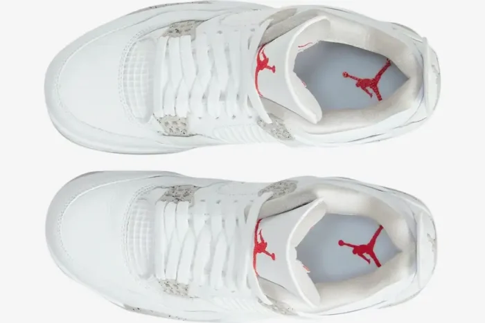 Top-down view of white Air Jordan 4 Retro White Oreo sneakers with grey speckled details and red logos. - SKU CT8527-100