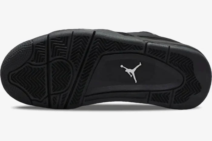 Bottom outsole view of the black Air Jordan 4 RM Black Cat Remastered shoe with a white Jumpman logo. - SKU FQ7939-004
