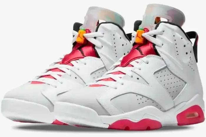 Three-quarter front view of Air Jordan 6 Retro Hare sneakers in white, grey, and red with orange lace toggles. - SKU CT8529-062
