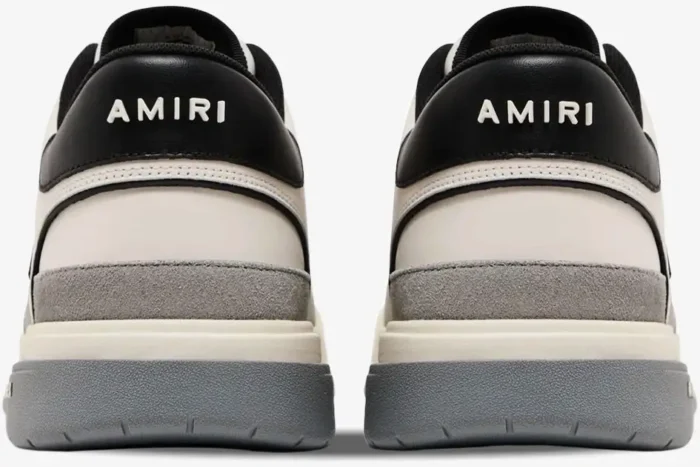 Rear view of Amiri Classic Low sneakers in white, grey, and black with logo on the heel. - SKU AMFOSR1067-001