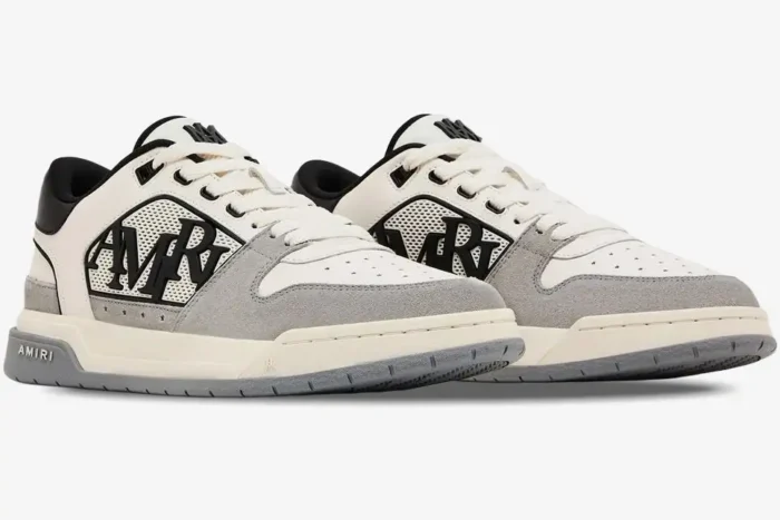 Amiri Classic Low luxury sneakers in white, grey, and black, shown from a side three-quarter angle. - SKU AMFOSR1067-001