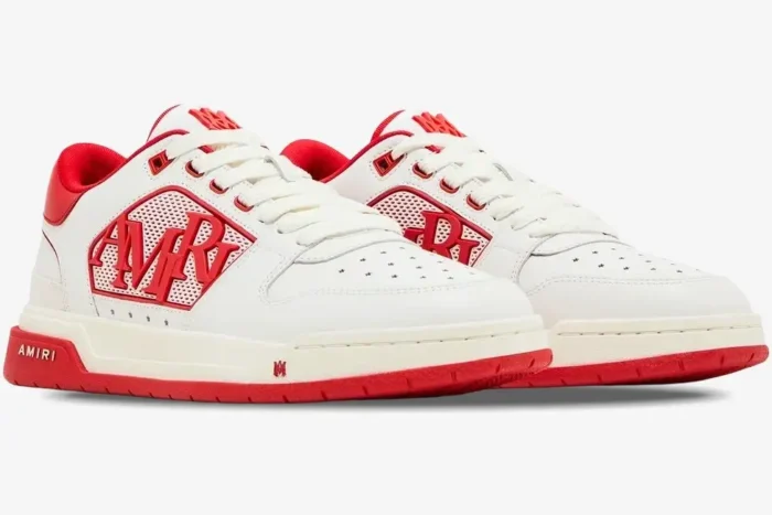 A pair of white and red Amiri Classic Low leather sneakers shown from a three-quarter angle. - SKU AMFOSR1043-147