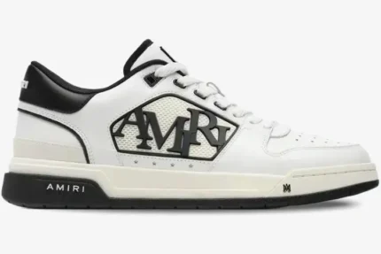 Amiri MA-1 Low sneaker in white and black leather, side profile view showing the large AMIRI logo. - SKU AMFOSR1043-111