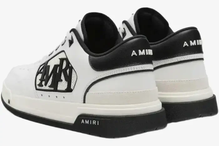 Rear view of Amiri MA-1 Low white and black leather sneakers showing the heel and side logo. - SKU AMFOSR1043-111
