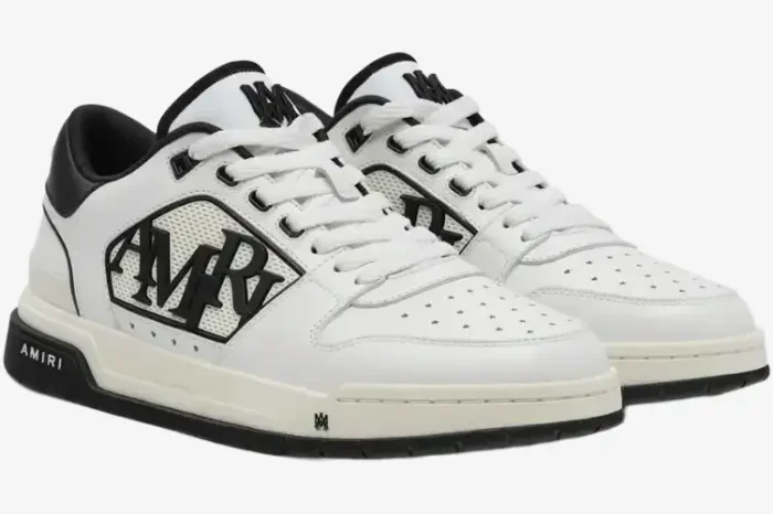 Amiri MA-1 Low white and black leather sneakers shown from a three-quarter side view. - SKU AMFOSR1043-111
