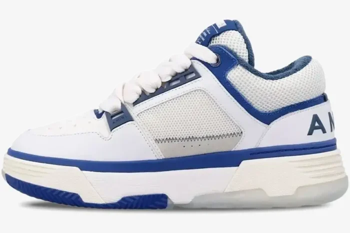Amiri MA-1 sneaker in white and blue, side profile view showing chunky sole and mesh panels. - SKU AMFOSR1048454
