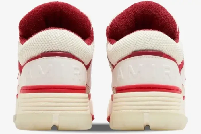 Rear view of Amiri MA-1 sneakers in white and red, featuring embossed heel logos and chunky soles. - SKU PS24MFS018-610