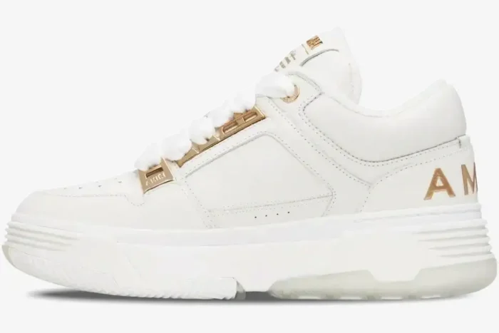 Amiri MA-1 Metallic White Gold sneakers in a side profile view with gold hardware. - SKU 252886M237010