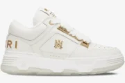 Amiri MA-1 Metallic White Gold sneaker in a side profile view featuring gold logo accents and a chunky sole. - SKU 252886M237010