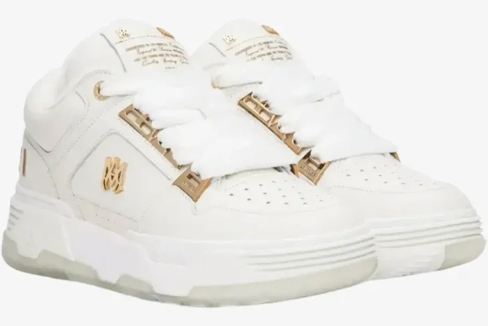 Three-quarter view of Amiri MA-1 metallic white gold sneakers with chunky soles and wide laces. - SKU 252886M237010