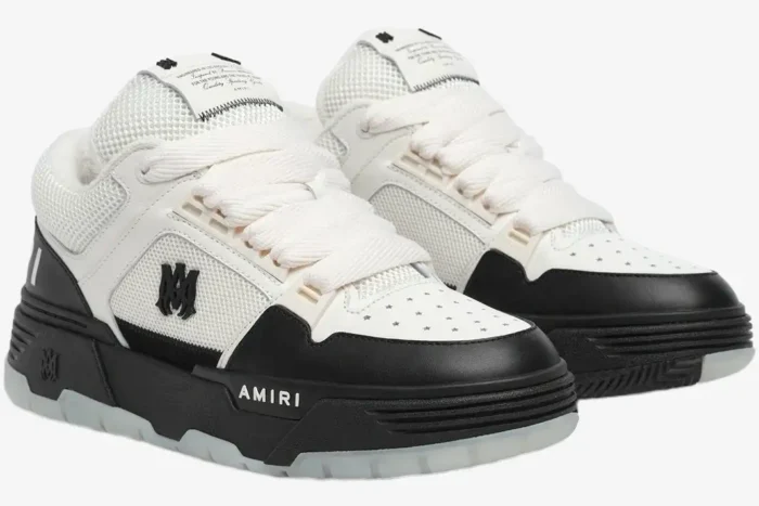 Amiri MA-1 sneakers in white and black, three-quarter front view showing chunky design and thick laces. - SKU AMFOSR1001-101