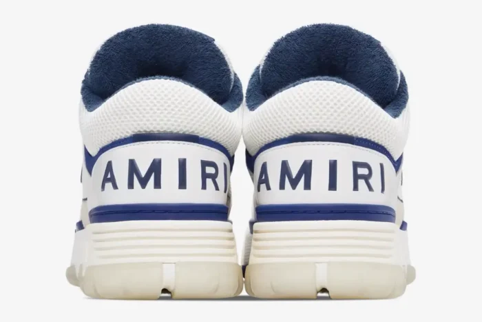 Rear view of Amiri MA-1 sneakers in white and blue, featuring bold heel branding and plush blue lining. - SKU AMFOSR1048454