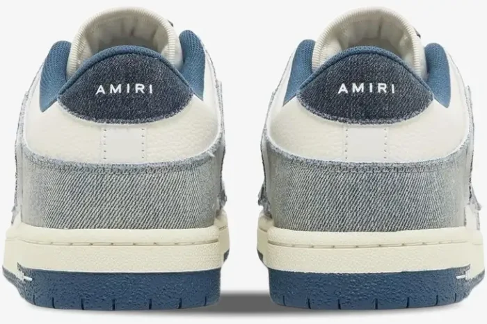 Back view of Amiri Skel Top Low sneakers in blue and white denim with AMIRI branding on the heel tabs. - SKU pf23mfs007-533