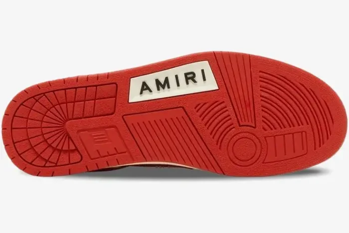 Red rubber outsole of Amiri Skel Top Low leather sneakers featuring a white brand logo. - SKU mfs003-124