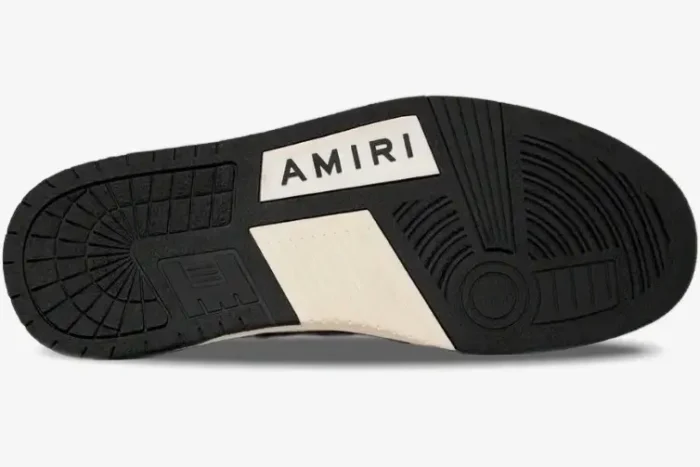 Bottom sole of an Amiri Skel Top Low sneaker in white and black, showing the tread pattern and logo. - SKU PS22MFS003-111
