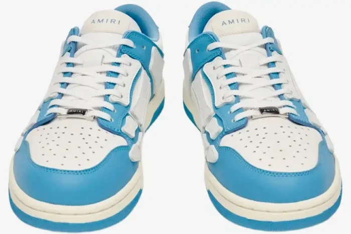 Front view of Amiri Skel Top Low sneakers in white and blue with skeleton overlays. - SKU MFS003-462