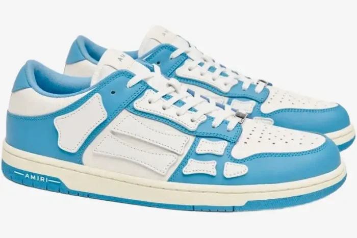 Amiri Skel Top Low sneakers in white and blue, side view showing skeleton bone leather overlays. - SKU MFS003-462