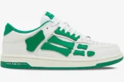 Side profile of Amiri Skel Top Low sneakers in white and green featuring skeleton-inspired leather patches. - SKU MFS003-114