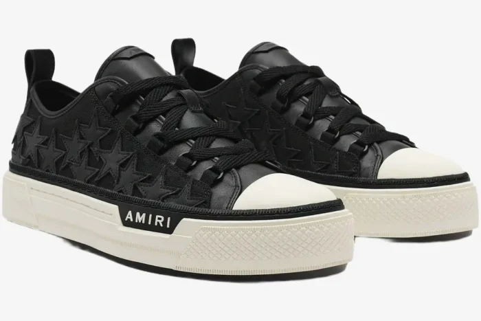 Amiri Stars Court black leather sneakers with star patches and white platform soles, three-quarter view. - SKU AMFOSR1178-083